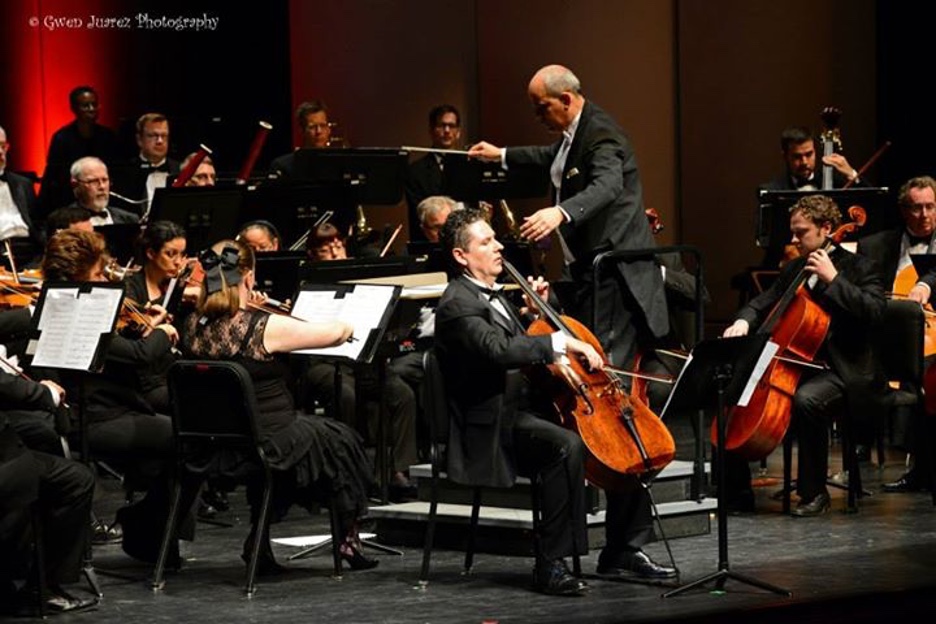 Marcelo Zigaran performing cello with orchestra and conductor